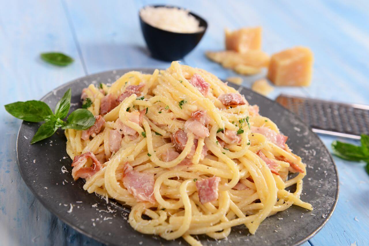 Creamy bacon one pot pasta with crispy bacon and Parmesan served from a Dutch oven